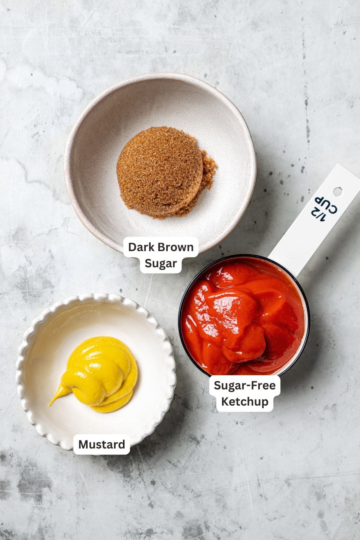 This easy copycat Cracker Barrel meatloaf recipe has juicy ground beef, veggies, and buttery Ritz crackers slathered in a sweet-tangy glaze. Meatloaf glaze ingredients with text labels overlaying each ingredient.