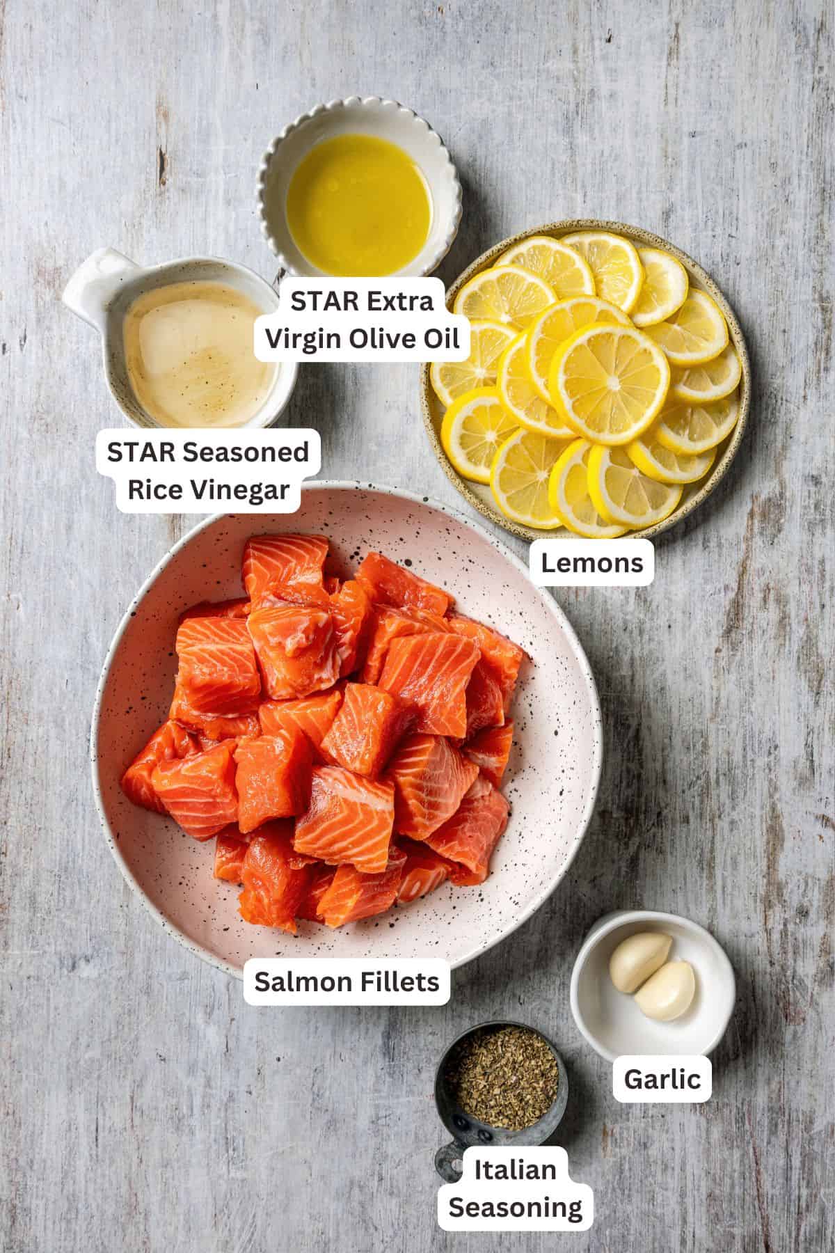 These juicy salmon kabobs with lemon are perfect for grilling! Serve with garlicky yogurt dipping sauce for a delicious and easy summer meal. Ingredients for salmon kabobs with text labels overlaying each ingredient.