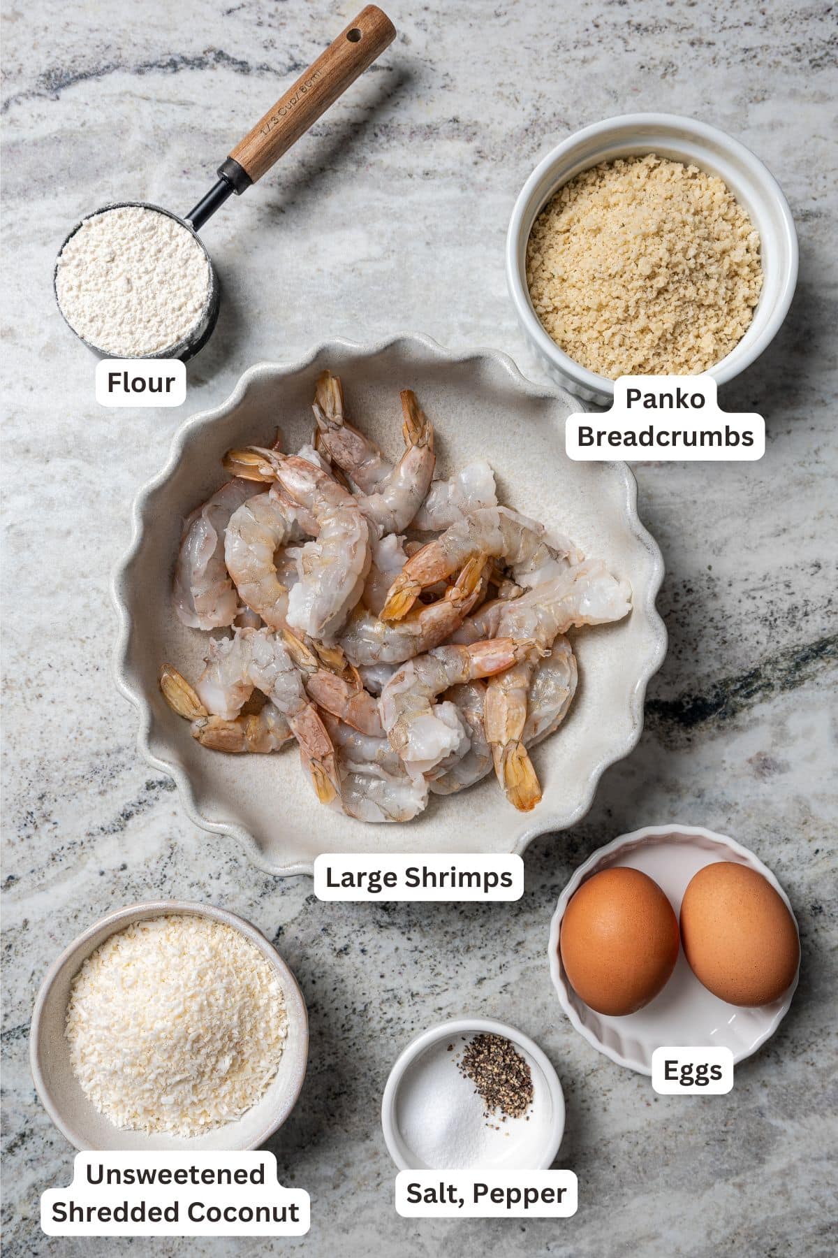 This easy coconut shrimp recipe makes crispy, golden-fried shrimp ready to dip in creamy sweet chili sauce. It's the best party appetizer! Coconut shrimp ingredients with text labels overlaying each ingredient.