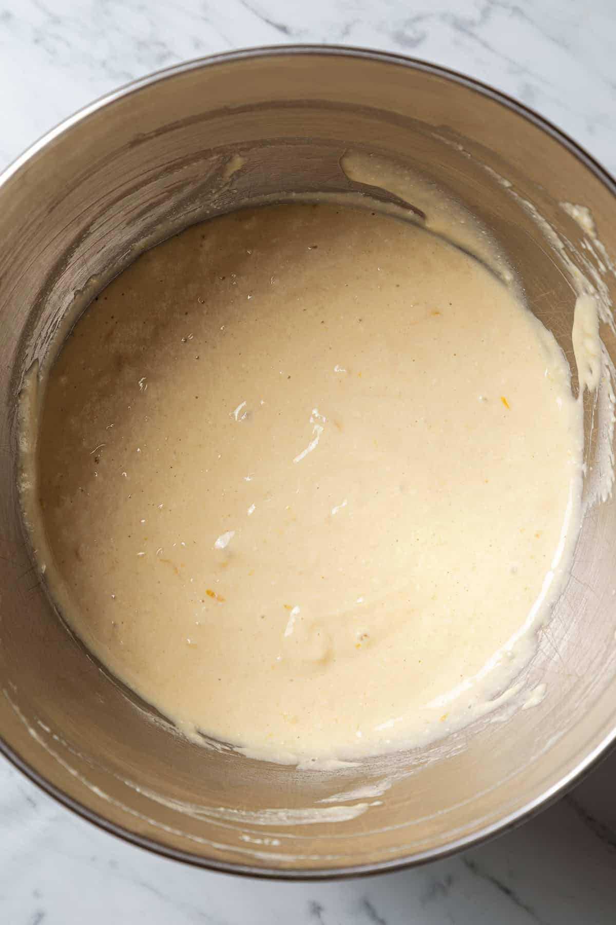 Lemon ricotta pancake batter in a metal bowl.