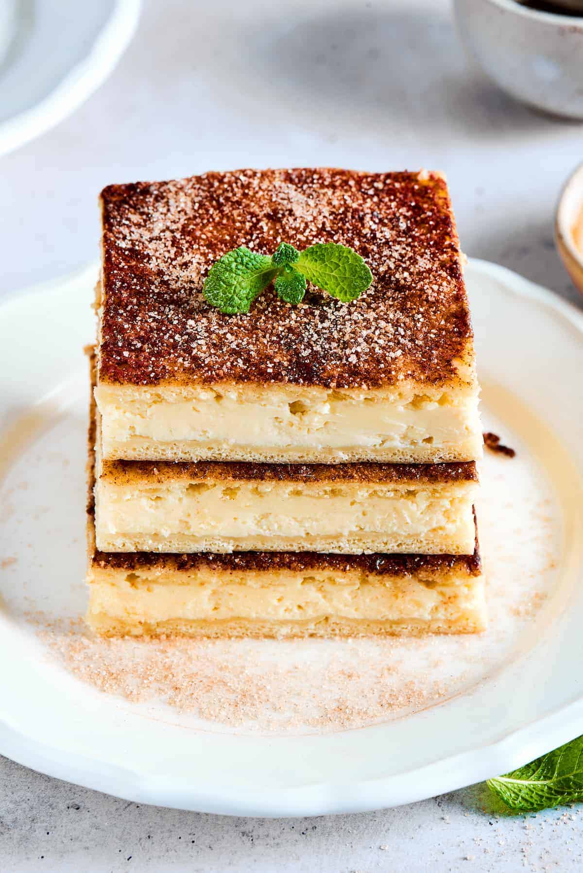 Sopapilla Cheesecake Three pieces of sopapilla cheesecake stacked up on a dessert plate.
