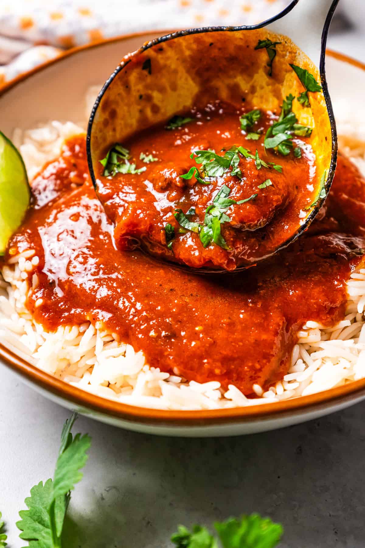 Spooning curry over rice.