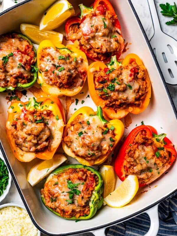 Ground turkey stuffed peppers arranged in a baking dish by dieethood.com