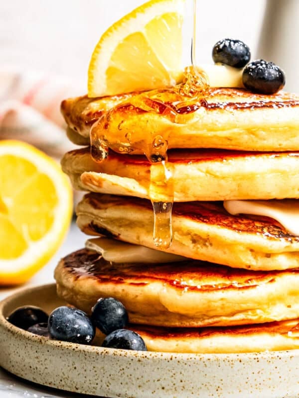 Syrup dripping down a stack of pancakes.