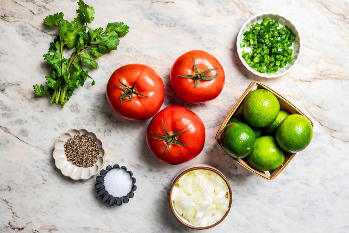 Pico de gallo is a fresh tomato salsa with only 5 ingredients: tomatoes, onion, jalapeño, cilantro, and lime. It’s quick and easy to make! Overhead photo of the ingredients that go into making Pico de gallo.