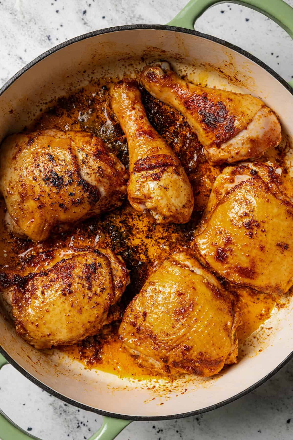 Classic arroz con pollo is a Latin favorite with juicy, seasoned chicken and rice brimming with smoky, savory flavor. Make it in one pot! Seared chicken in a large pot.