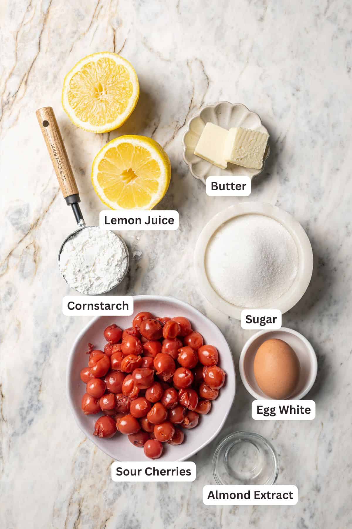 This is the best cherry pie recipe with thick, juicy cherry pie filling flavored with a touch of almond, baked in a buttery, flaky pie crust. Cherry pie filling ingredients with text labels overlaying each ingredient.