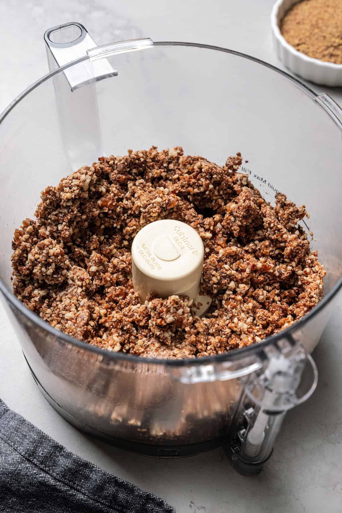 These easy no-bake energy balls are the perfect on-the-go snack packed with juicy dates, raw almonds, chocolate, and nut butter. No oats! Energy ball mixture inside the food processor.