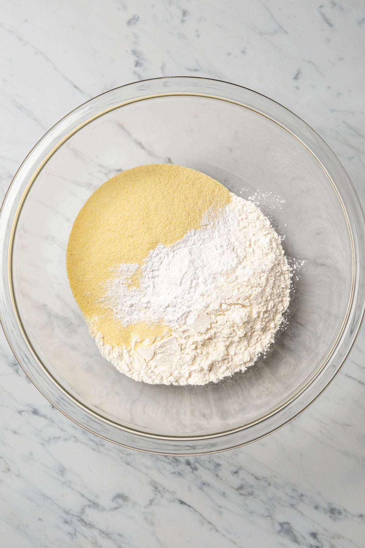 Dry ingredients combined in a glass bowl.