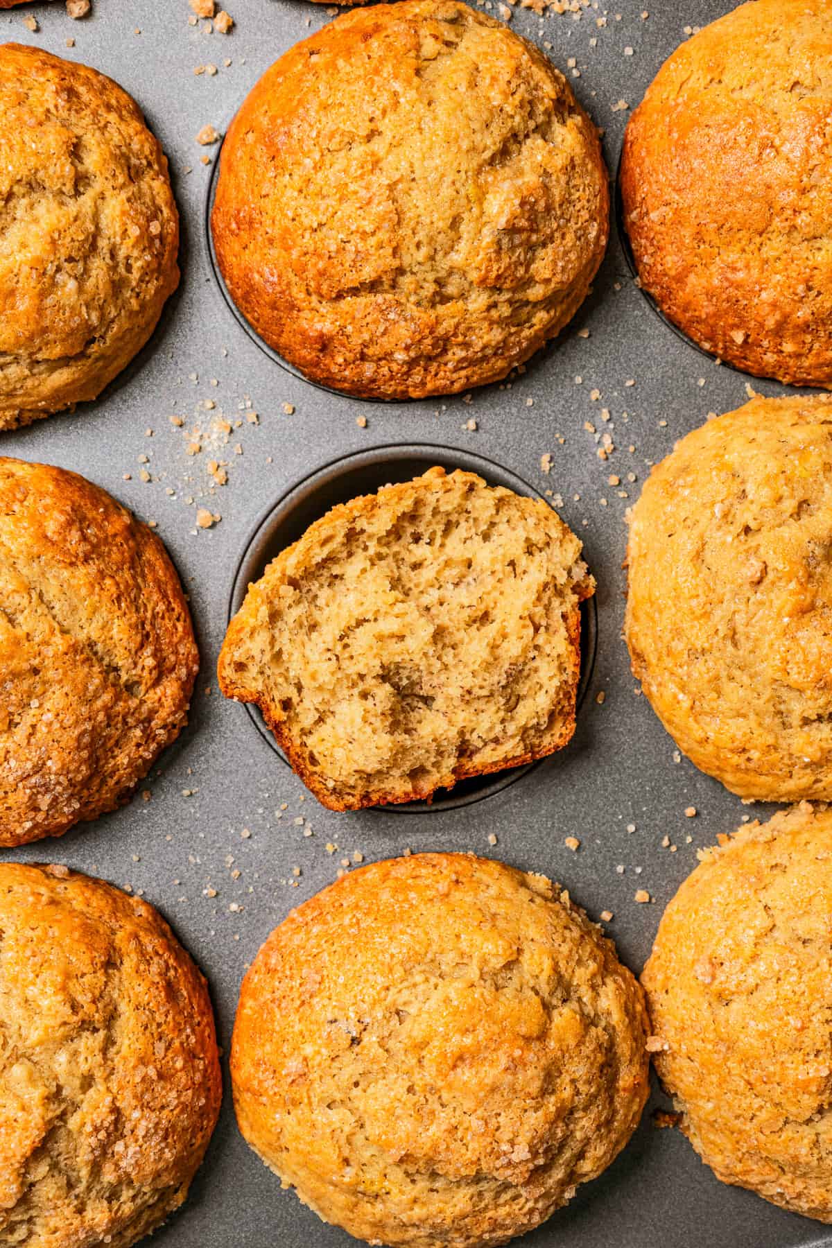 These soft, buttery banana bread muffins are easy to make with maple syrup, brown sugar, and cinnamon. It's impossible to eat just one! Banana muffins in a muffin tin.