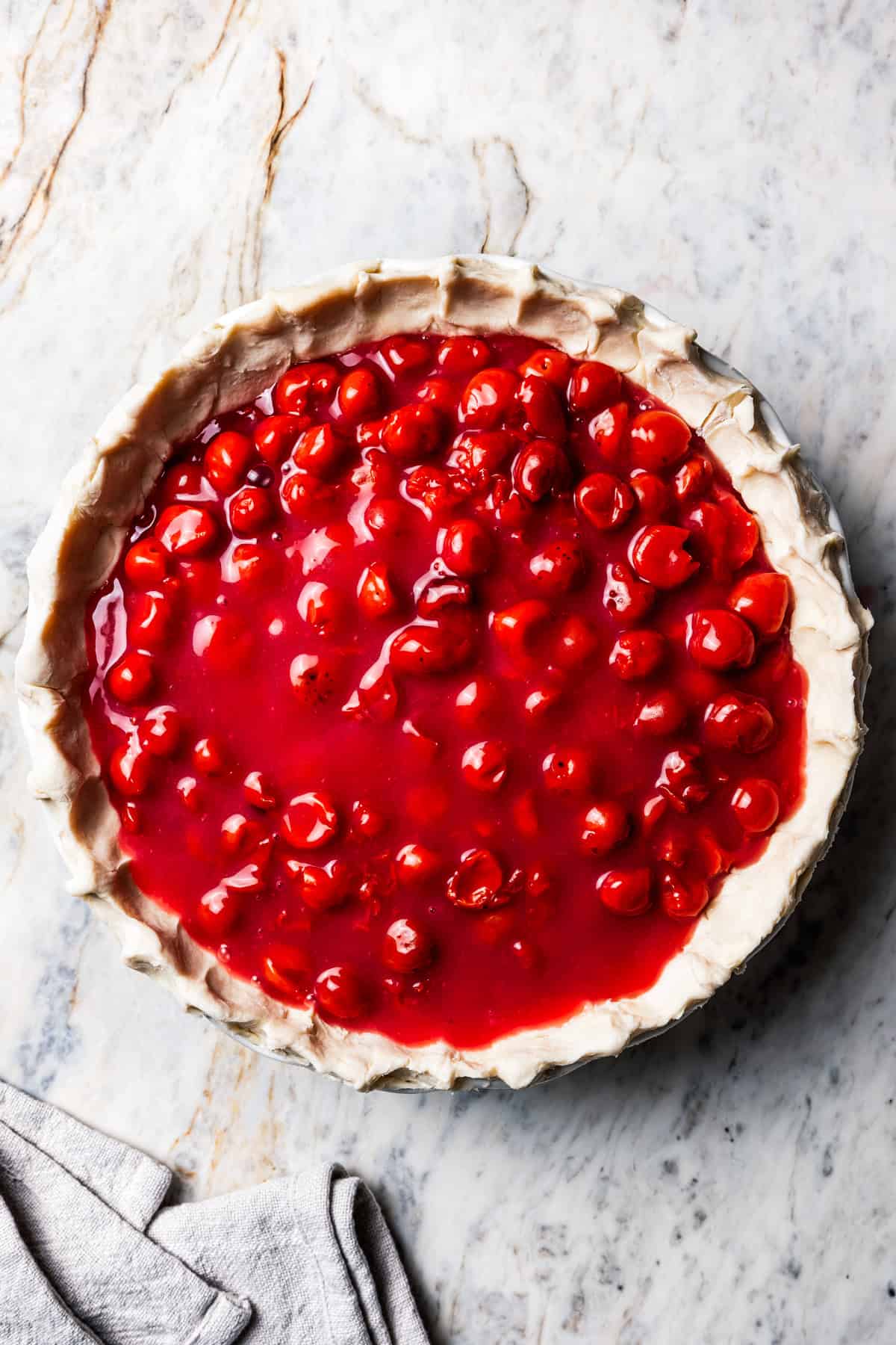 This is the best cherry pie recipe with thick, juicy cherry pie filling flavored with a touch of almond, baked in a buttery, flaky pie crust. Cherry pie filling inside a pie crust.
