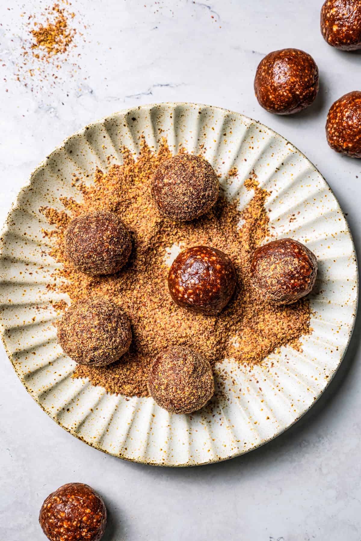 These easy no-bake energy balls are the perfect on-the-go snack packed with juicy dates, raw almonds, chocolate, and nut butter. No oats! Rolling energy balls in wheat germ.