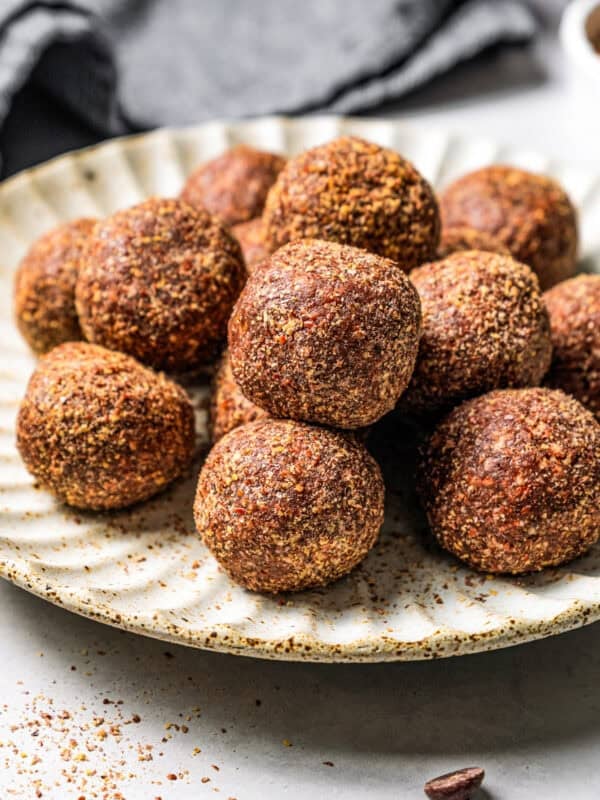 Energy balls piled on a plate.