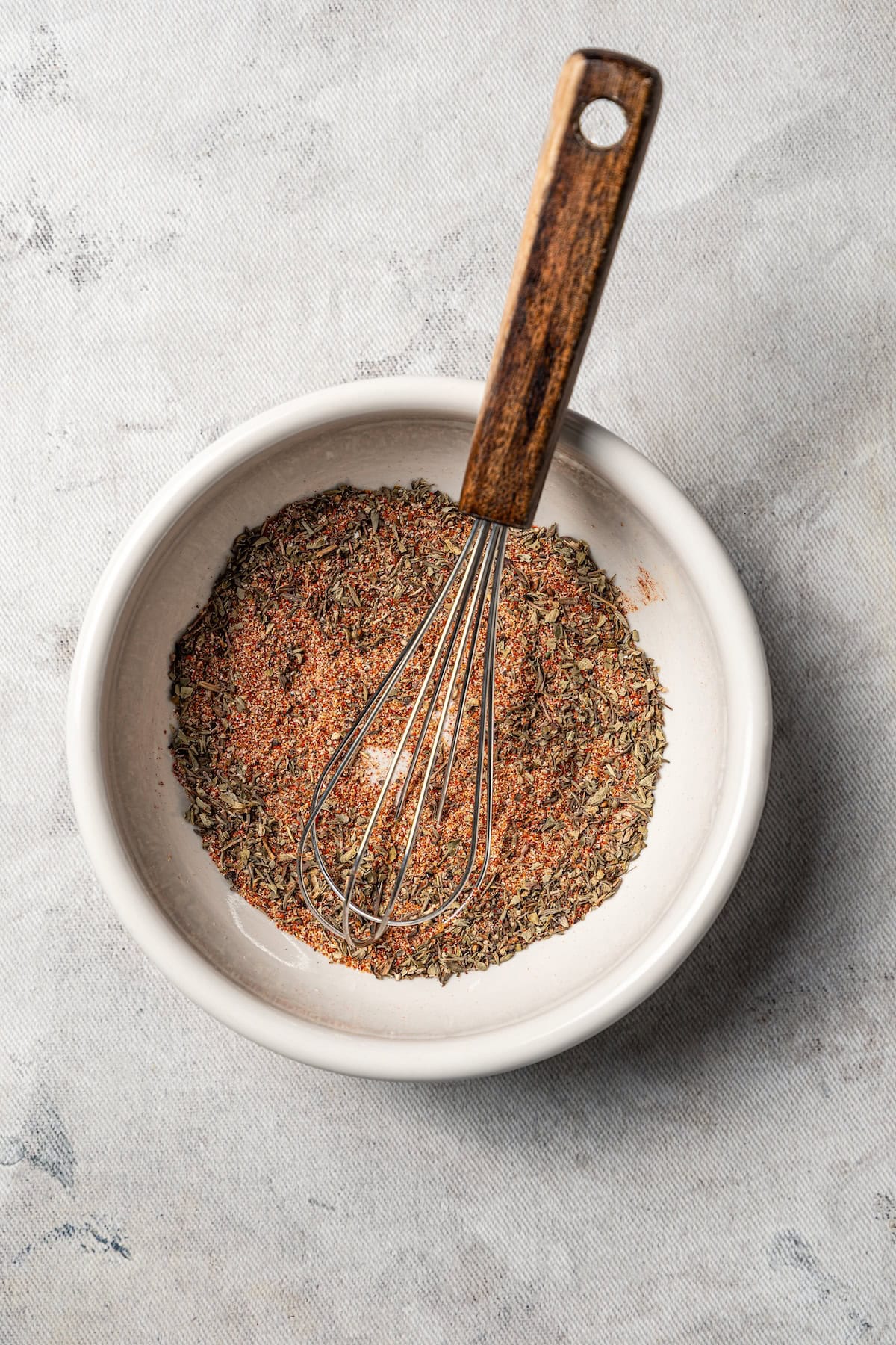Blackened mahi mahi is a quick fish dish packed with Southern flavor thanks to a spicy homemade Cajun seasoning rub. Great for weeknights! Blackened seasoning in a bowl with a whisk.
