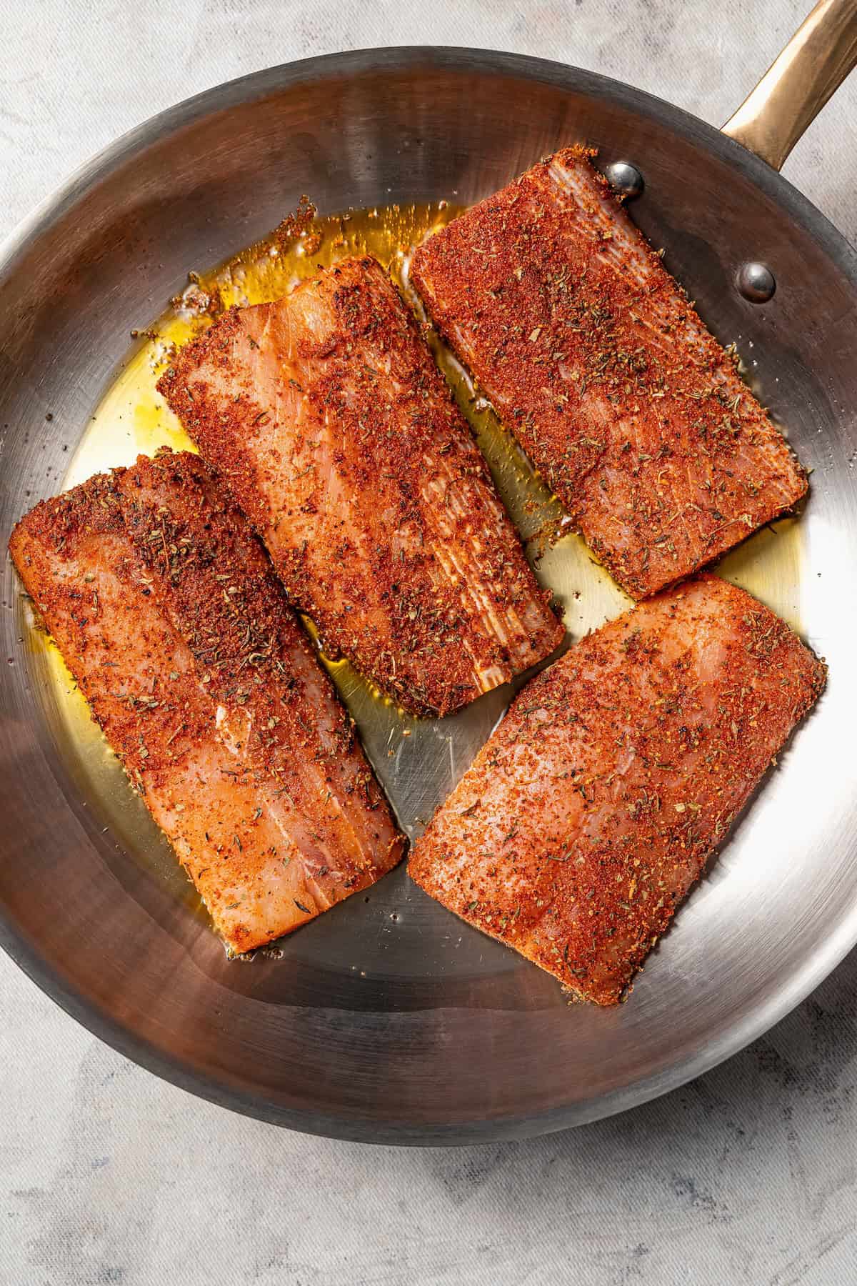 Blackened mahi mahi is a quick fish dish packed with Southern flavor thanks to a spicy homemade Cajun seasoning rub. Great for weeknights! Blackened mahi mahi filets in a skillet.