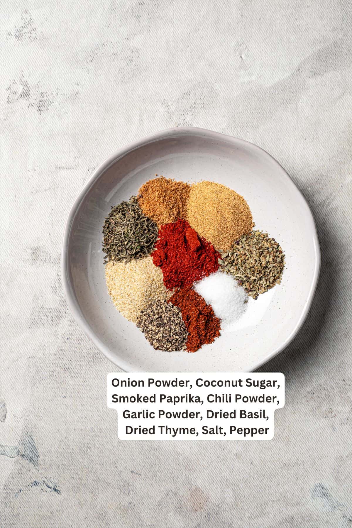 Blackened mahi mahi is a quick fish dish packed with Southern flavor thanks to a spicy homemade Cajun seasoning rub. Great for weeknights! Blackened seasoning ingredients combined in a bowl with text labels over each spice.