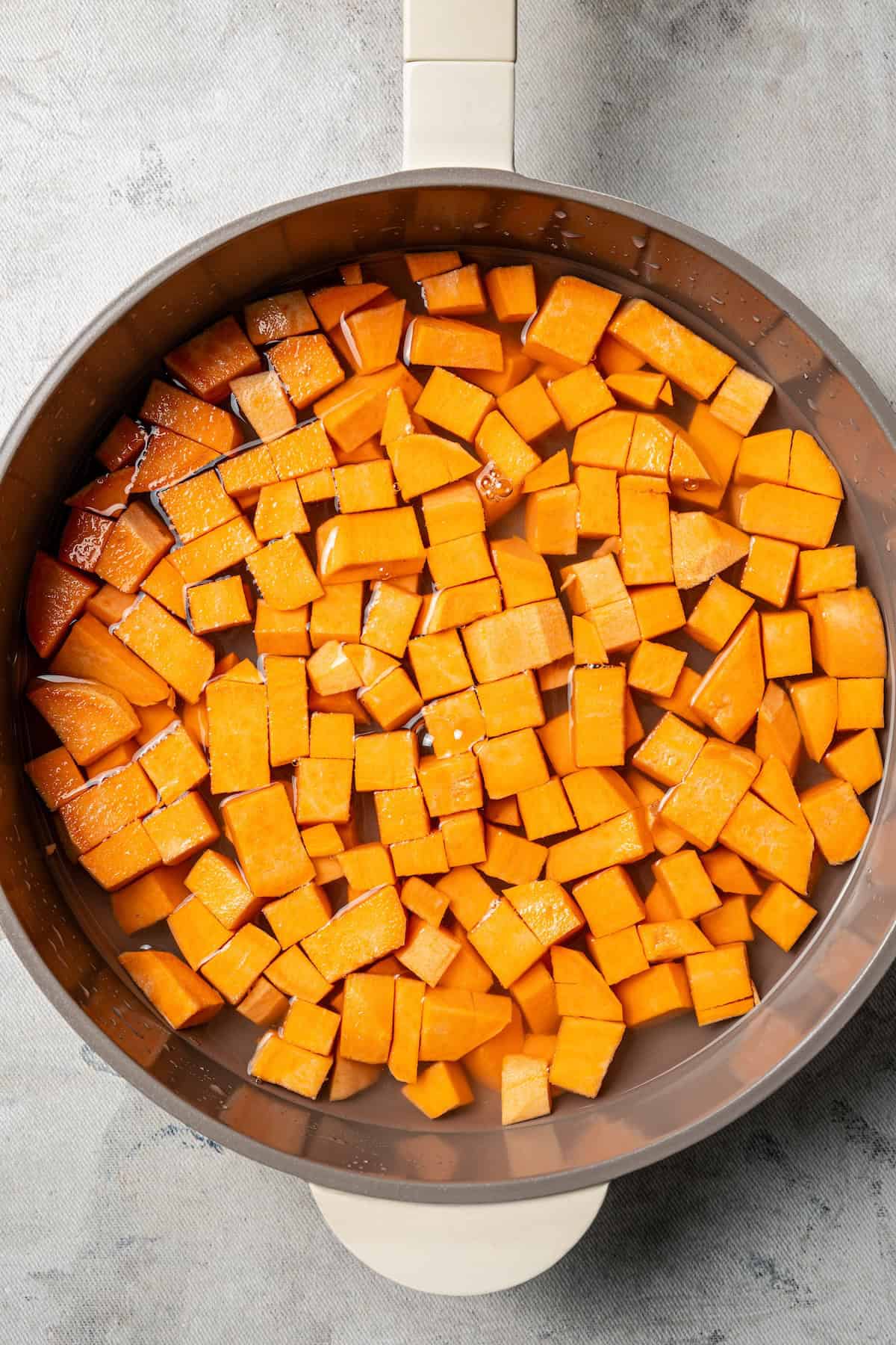Diced sweet potatoes in a saucepan.