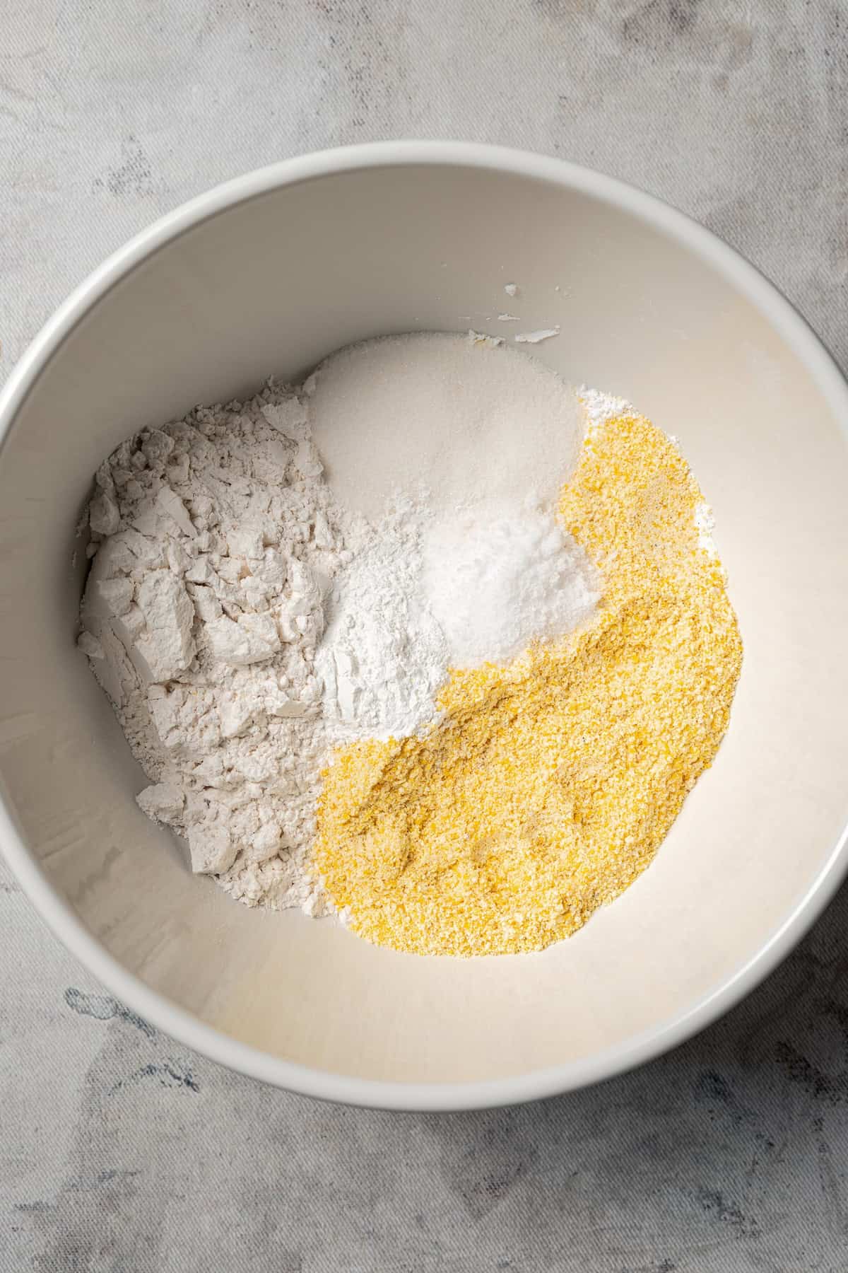 Dry cornbread ingredients combined in a bowl.