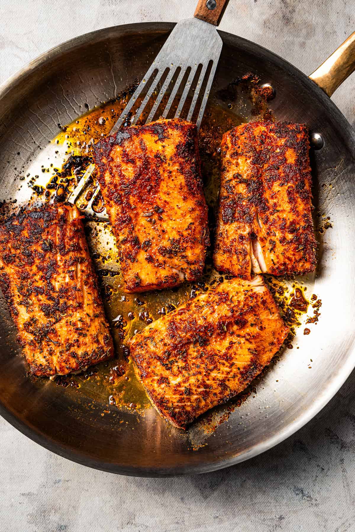 Blackened mahi mahi is a quick fish dish packed with Southern flavor thanks to a spicy homemade Cajun seasoning rub. Great for weeknights! Seared mahi mahi filets in a skillet with a spatula.