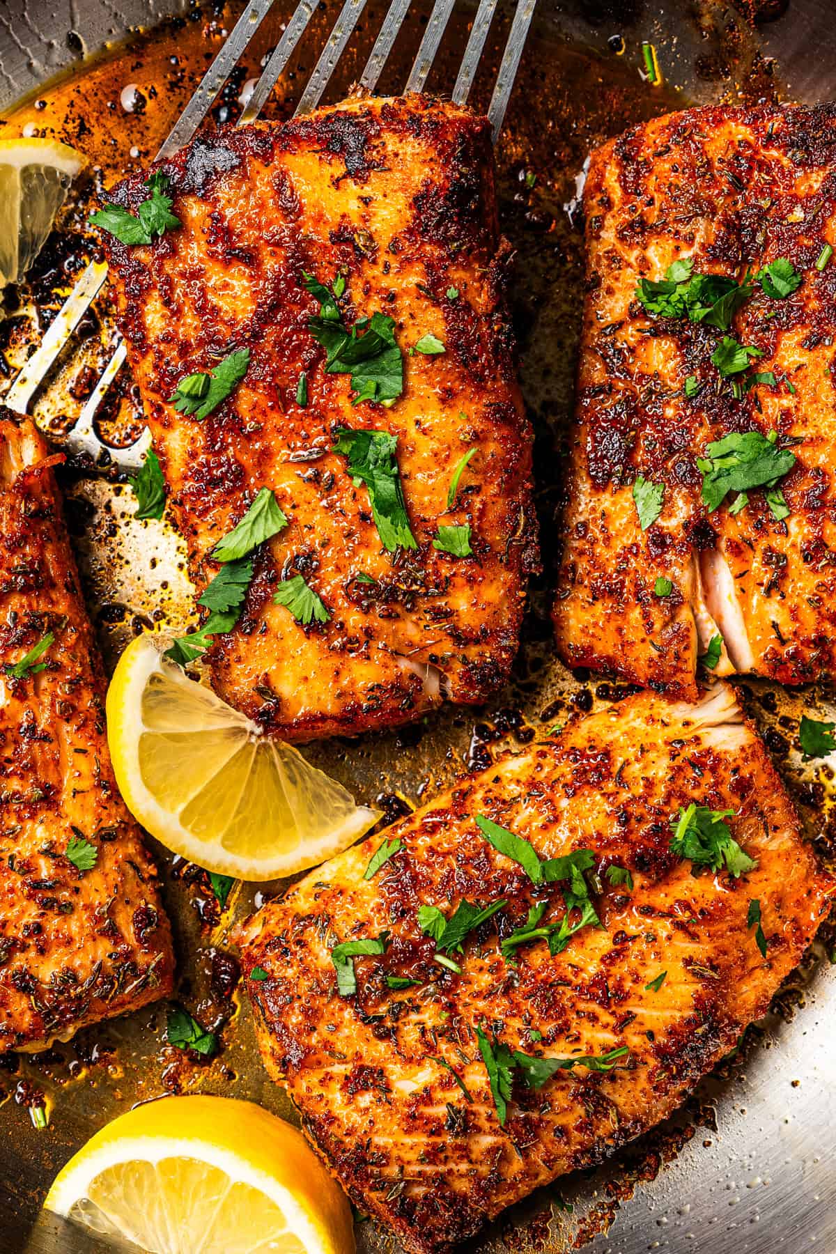 Blackened mahi mahi is a quick fish dish packed with Southern flavor thanks to a spicy homemade Cajun seasoning rub. Great for weeknights! Blackened mahi mahi fish in a skillet with a spatula lifting one up.