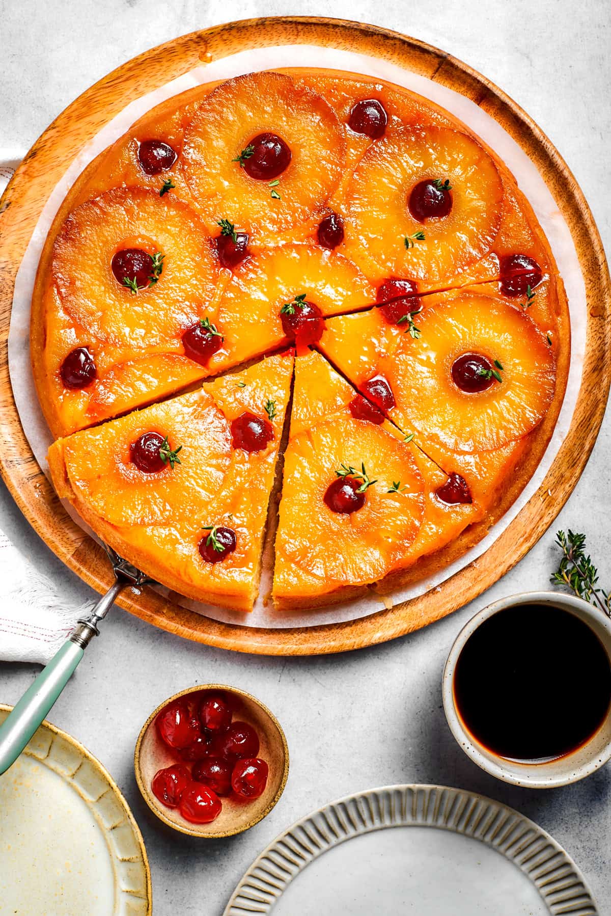 Lemon Ricotta Pancakes Overhead view of a round cake topped with pineapple rings and maraschino cherries.