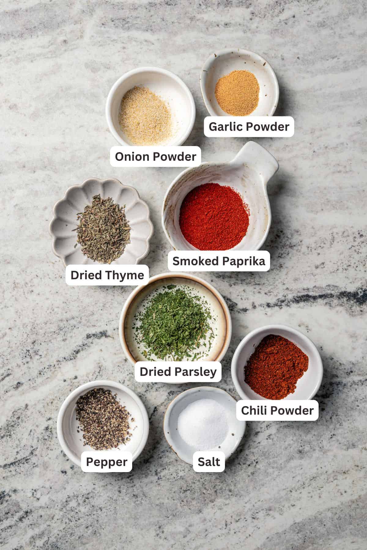 Chicken burger seasoning ingredients with text labels overlaying each ingredient.