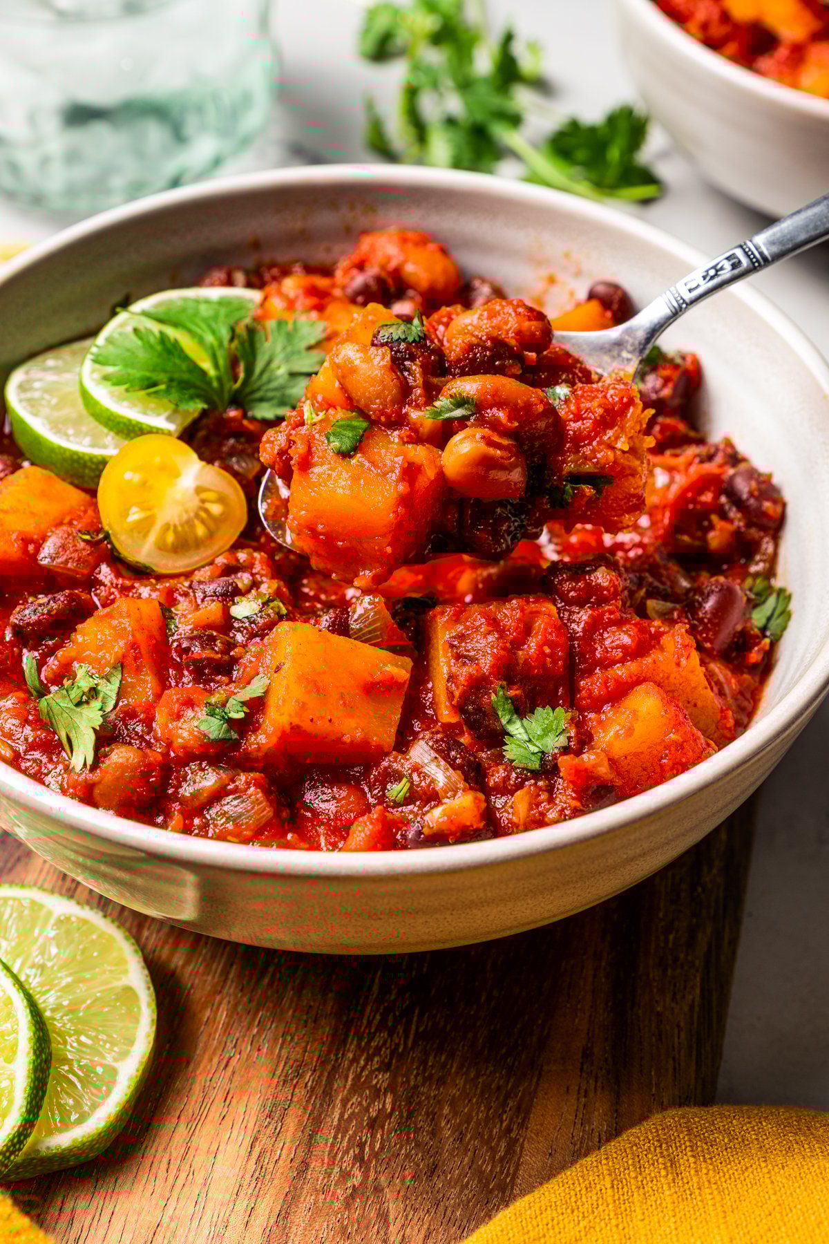 A spoonful of butternut squash chili spooned from a bowl.