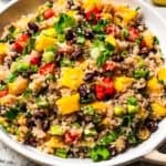 Quinoa black bean salad in a large stoneware serving bowl.