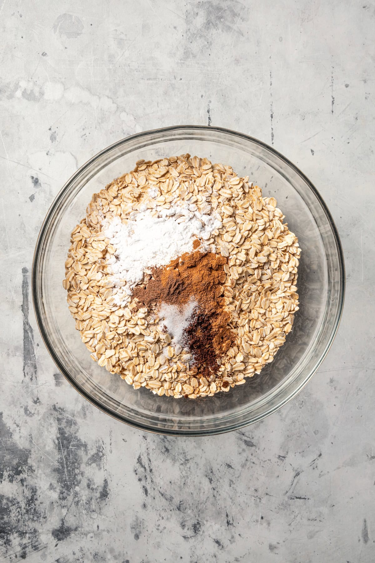 Dry oatmeal ingredients combined in a mixing bowl.