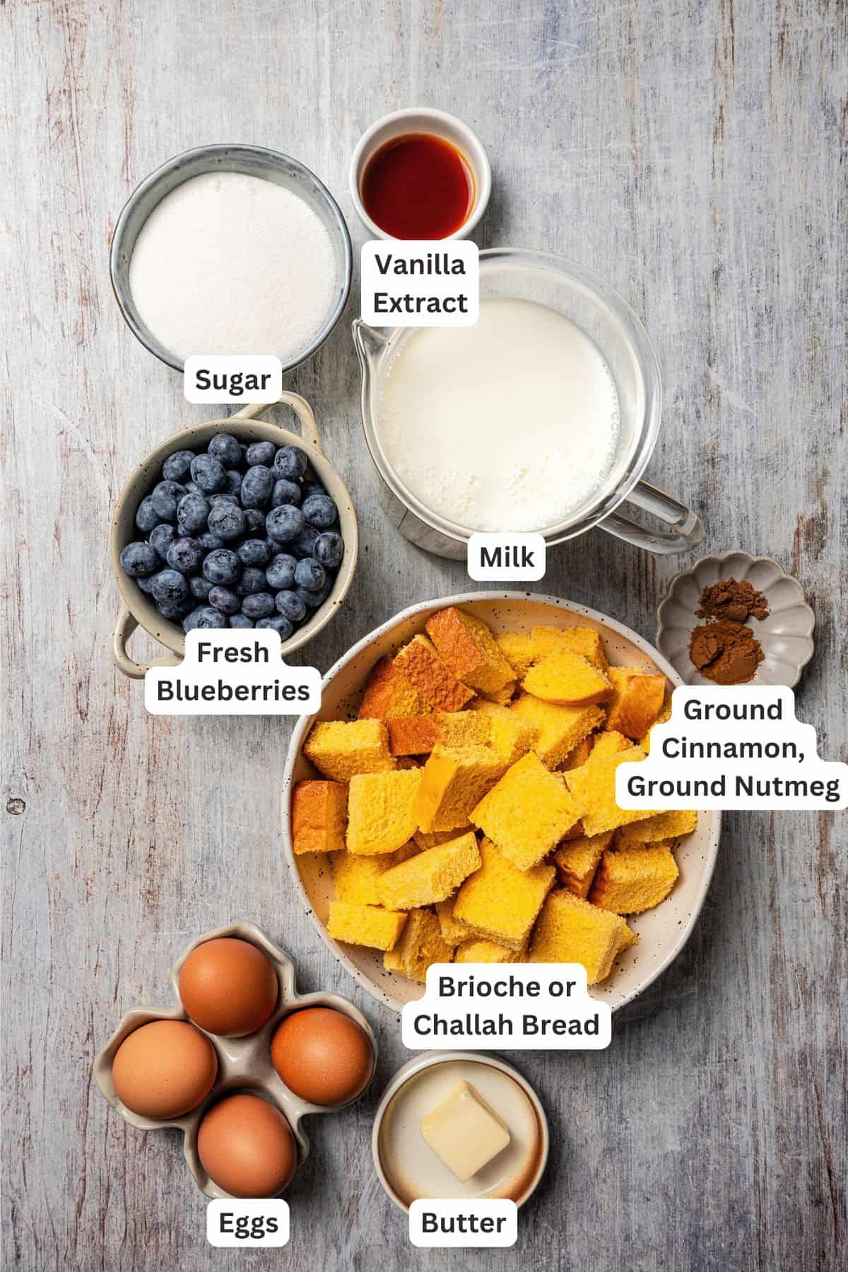 Blueberry bread pudding ingredients with text labels overlaying each ingredient.