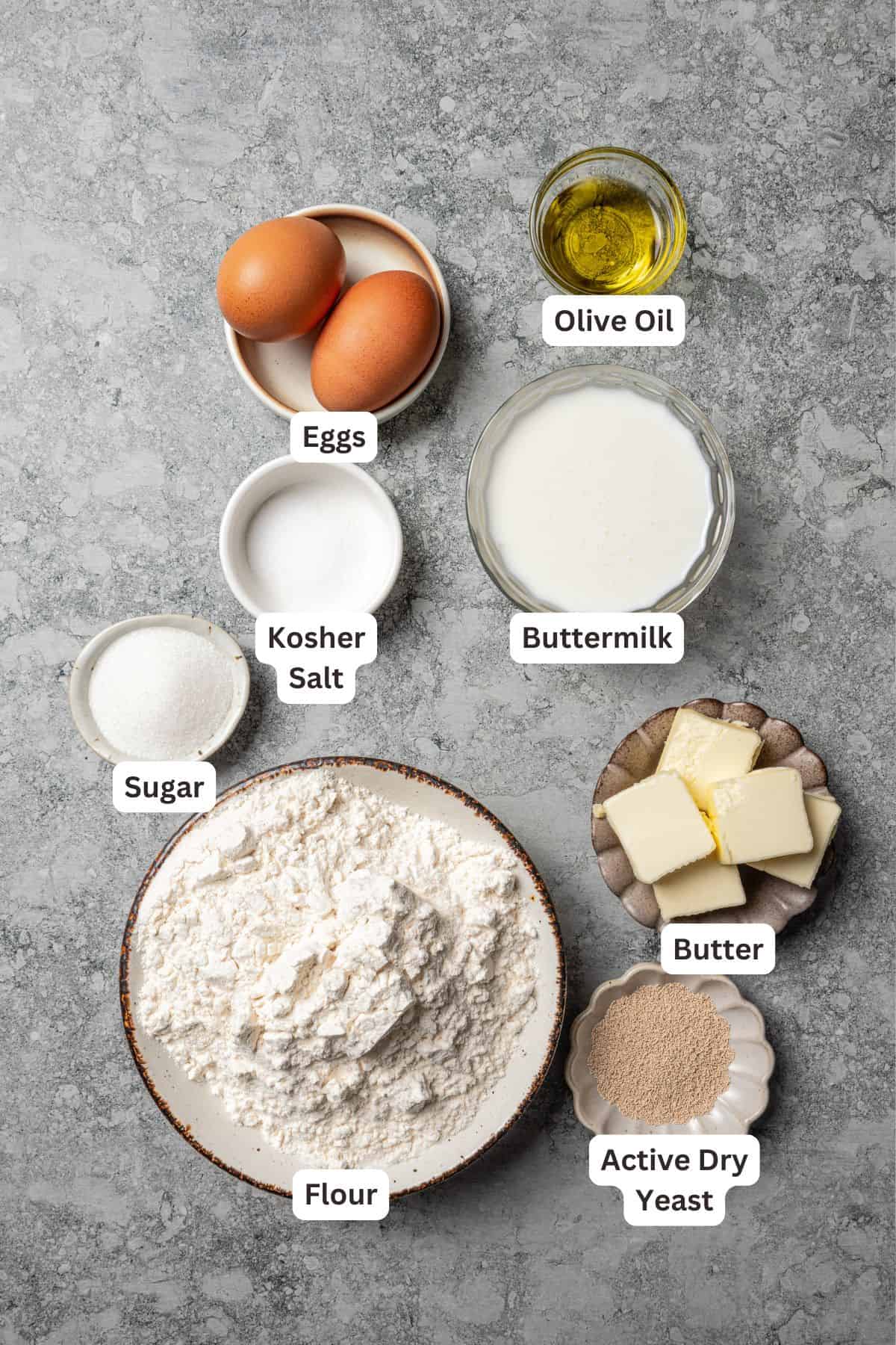 Cinnamon roll dough ingredients with text labels overlaying each ingredient.