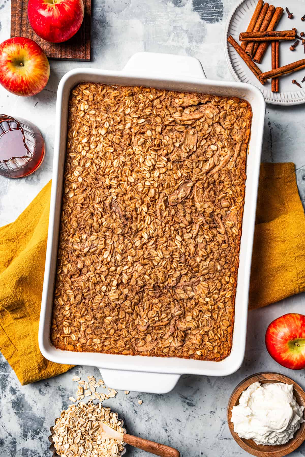 Overhead view of baked apple oatmeal inside a ceramic baking dish.