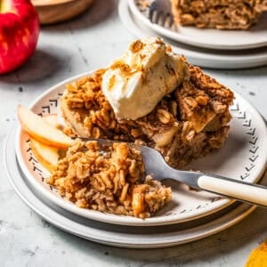 A fork cutting into baked apple oatmeal.