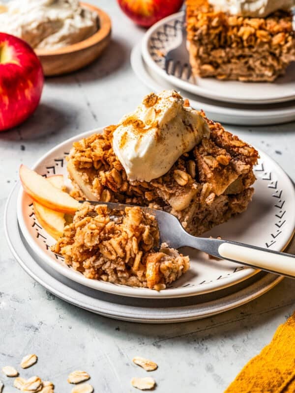 A fork cutting into baked apple oatmeal.