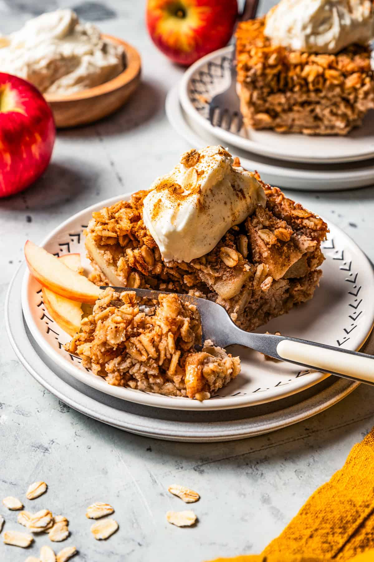 A fork cutting into baked apple oatmeal.