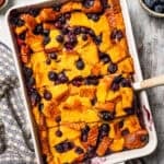 A baking dish with blueberry bread pudding.