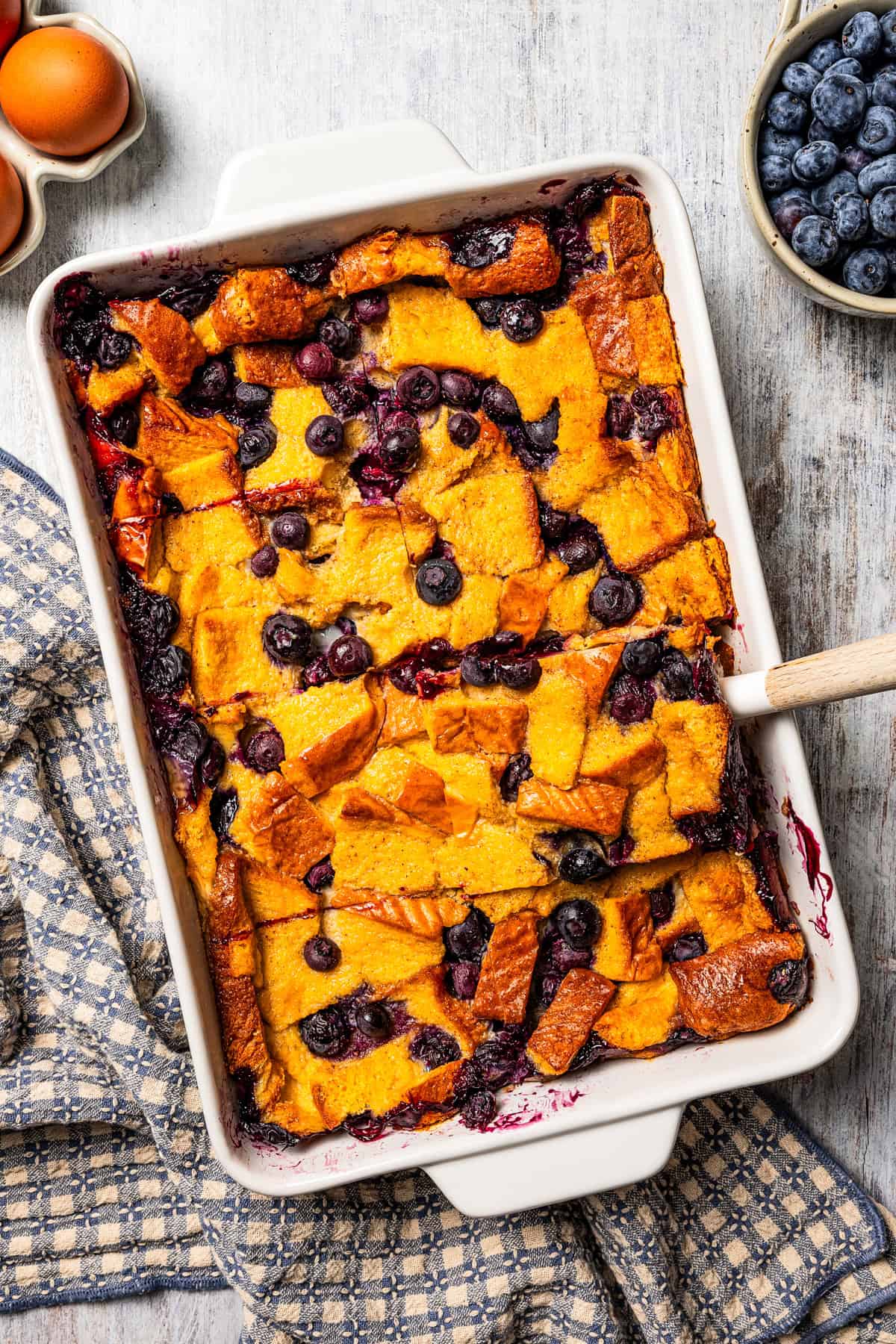 A baking dish with blueberry bread pudding.
