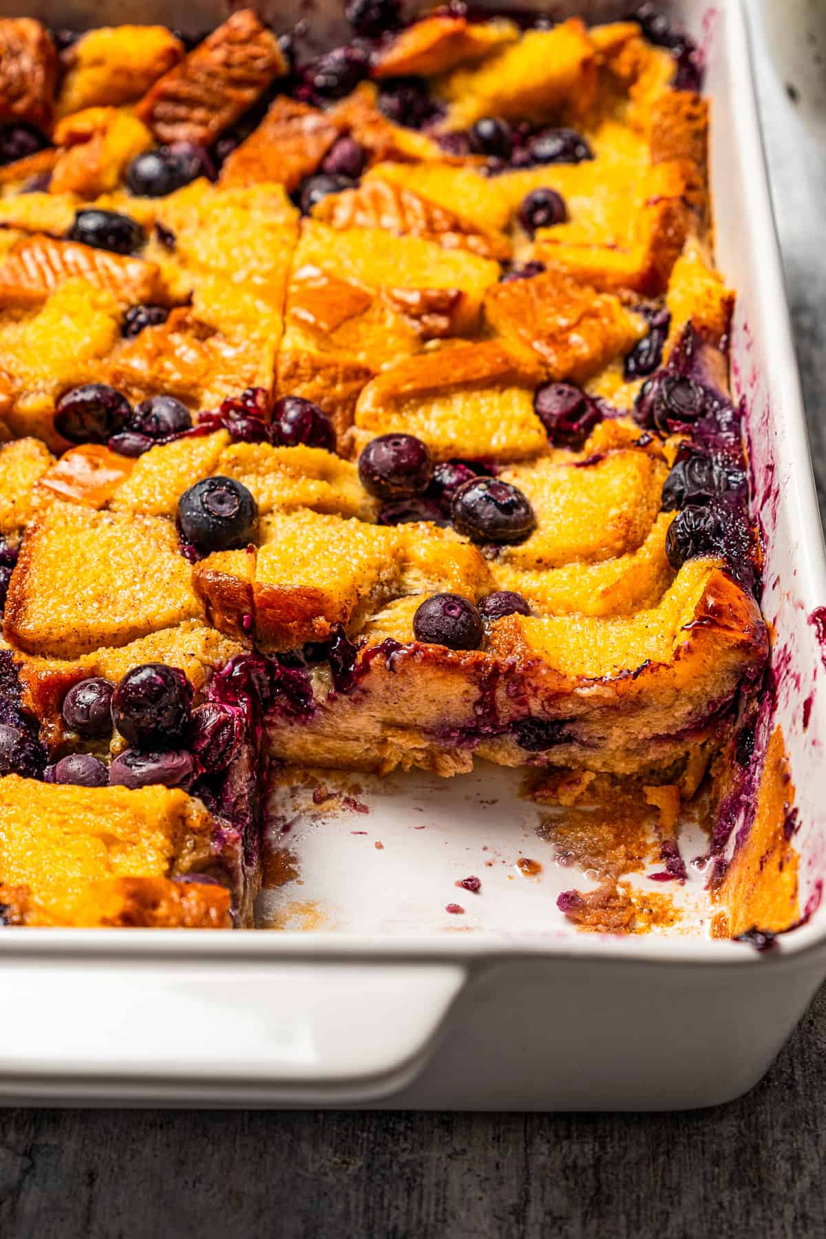 Side view of blueberry bread pudding in a baking dish.