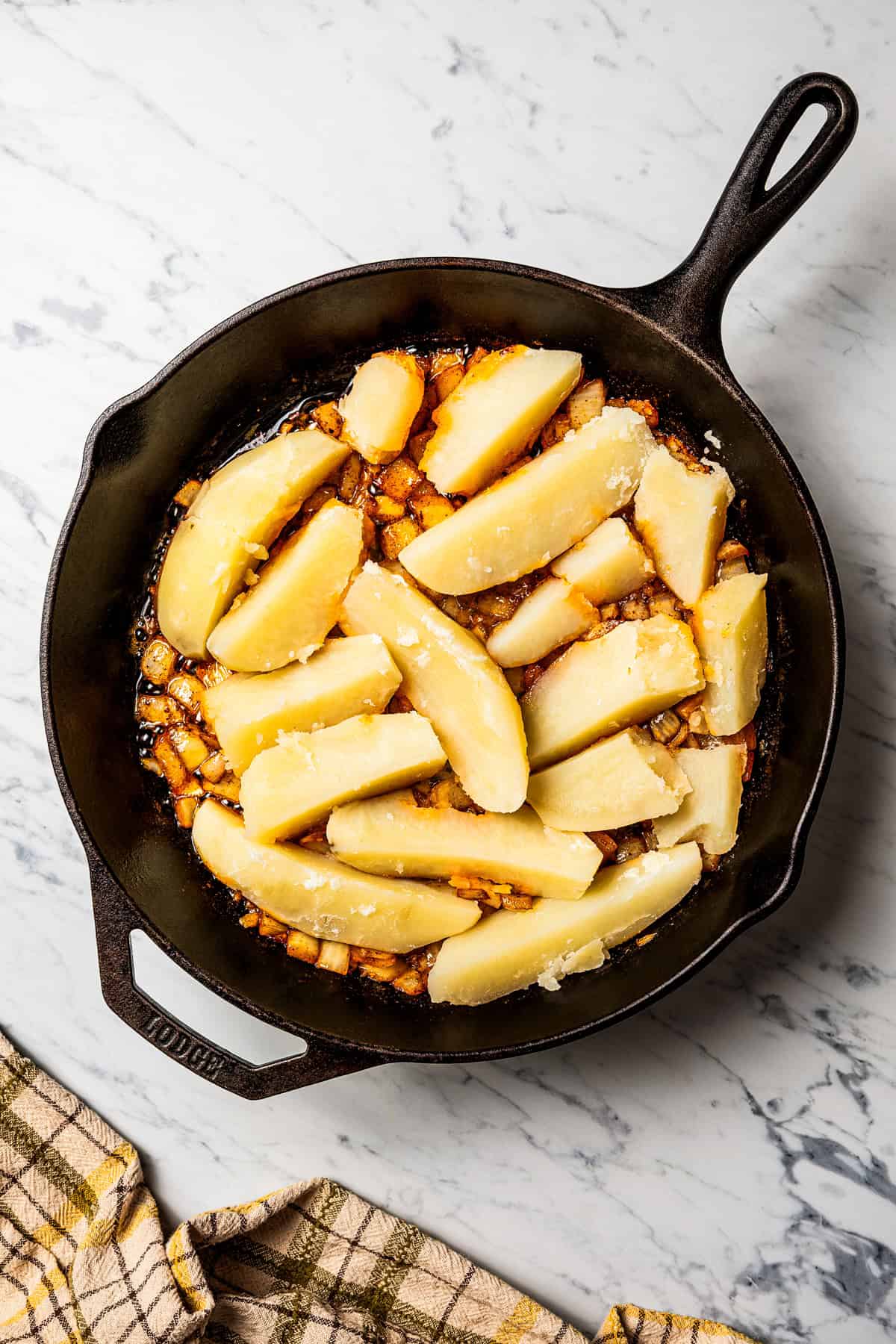 These seasoned and crispy breakfast potatoes are boiled, pan-fried, and finished in the oven so they're fluffy inside with golden-brown edges. Boiled potatoes added to a skillet with onions, butter, and spices.