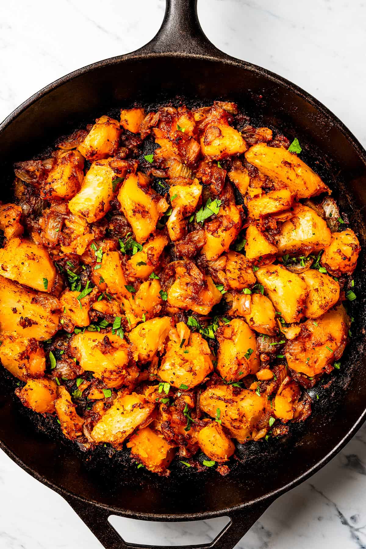 These seasoned and crispy breakfast potatoes are boiled, pan-fried, and finished in the oven so they're fluffy inside with golden-brown edges. Breakfast potatoes in a skillet.