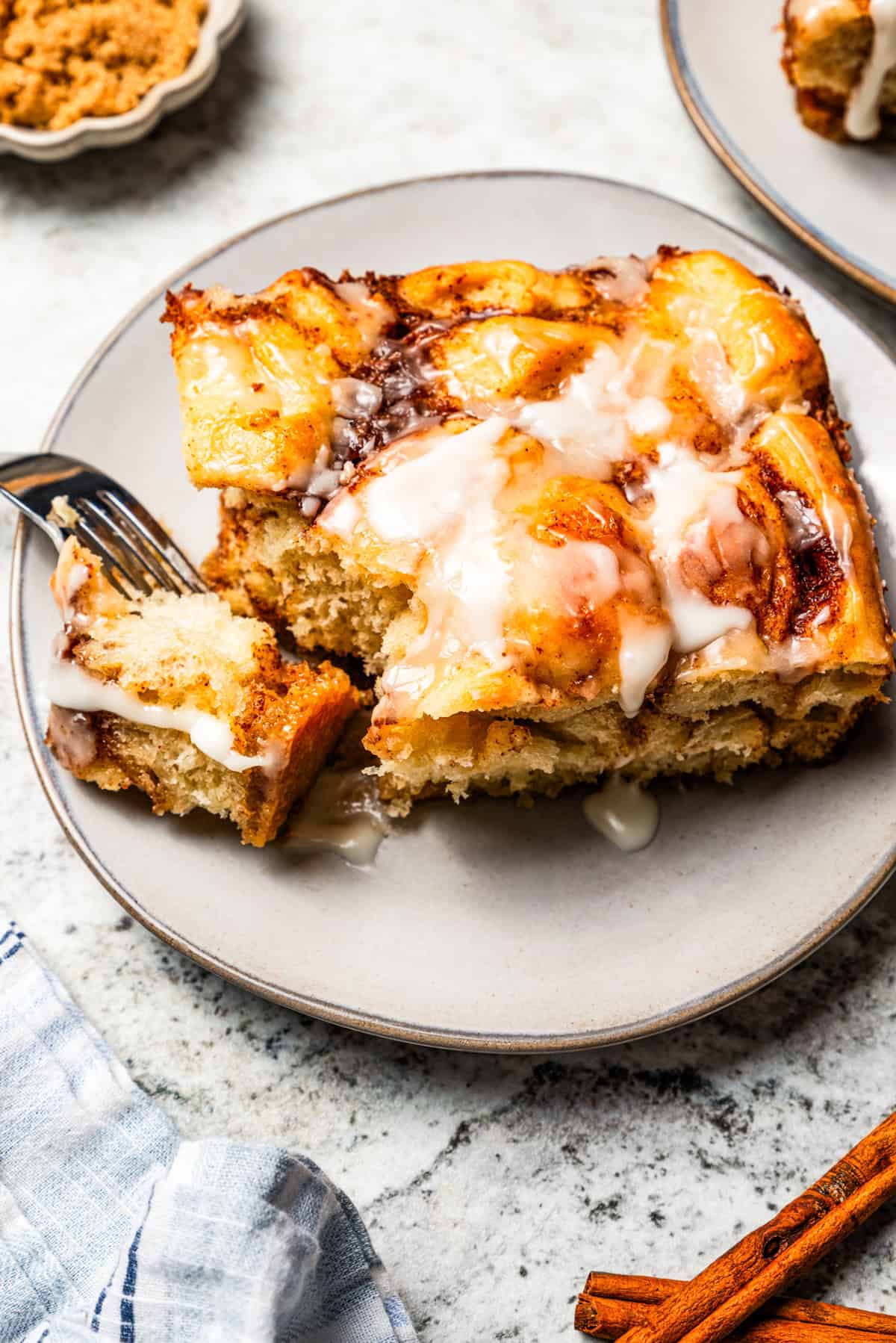 Cinnamon roll casserole piece served on a plate.