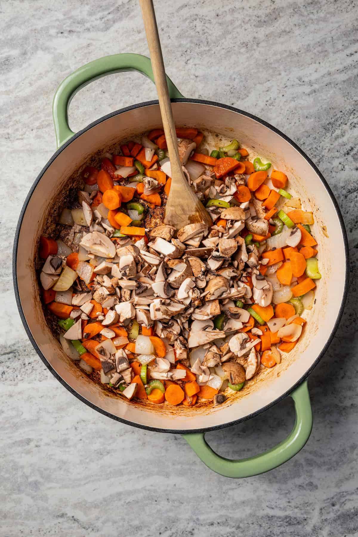This easy beef pot pie recipe has a hearty, savory filling of juicy braised beef and tender veggies baked inside a flaky homemade pie crust. Diced vegetables added to a skillet.