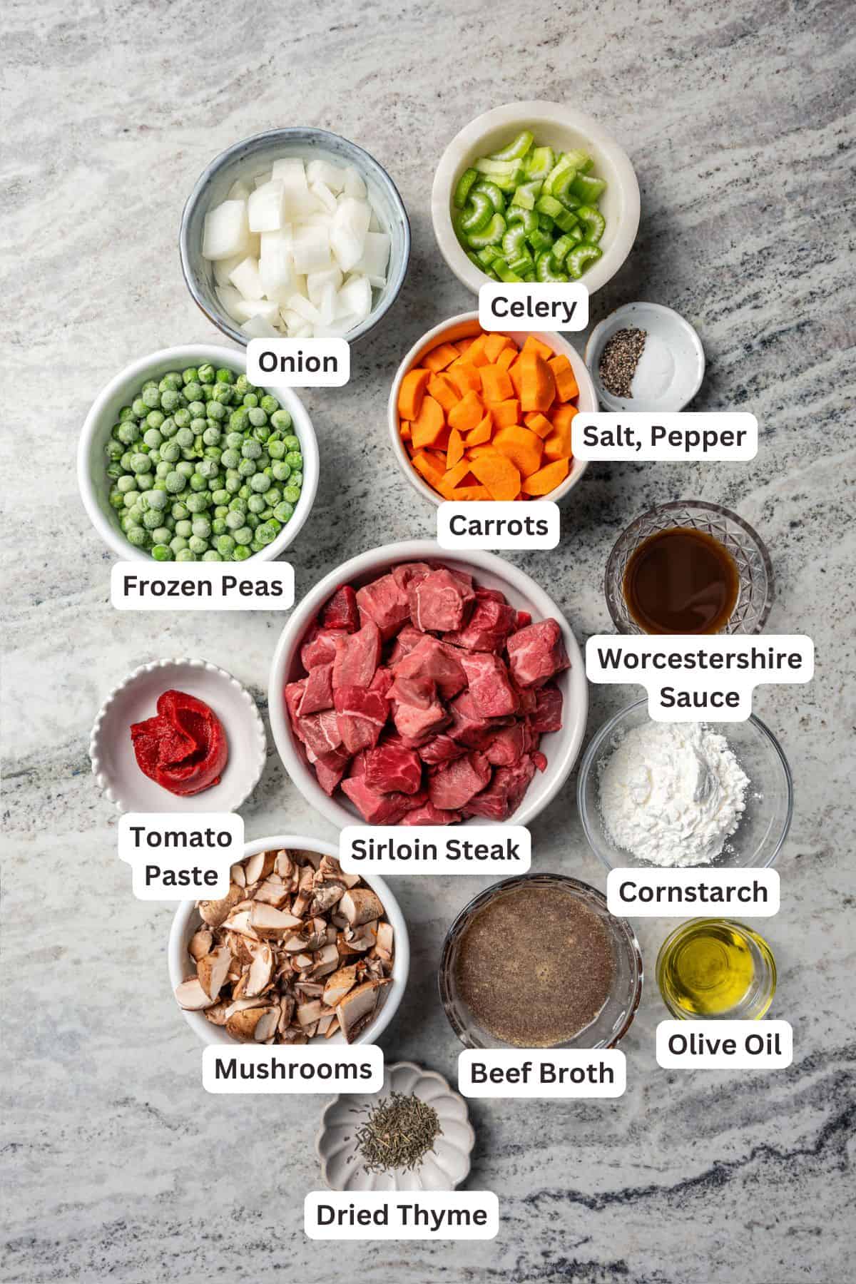 This easy beef pot pie recipe has a hearty, savory filling of juicy braised beef and tender veggies baked inside a flaky homemade pie crust. Beef pot pie ingredients with text labels overlaying each ingredient.