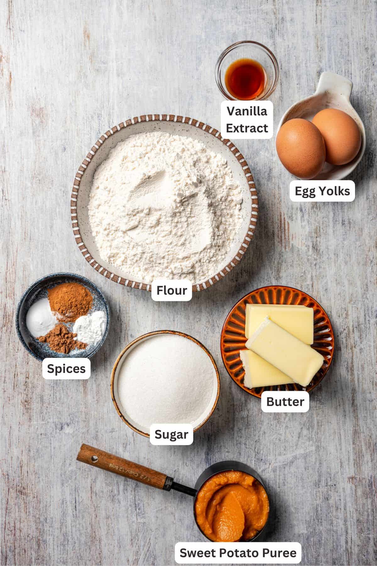 These easy, soft-baked sweet potato cookies are made with sweet potato purée, fall spices, and stuffed with sweet cream cheese in the middle! Sweet potato cookies ingredients with text labels overlaying each ingredient.