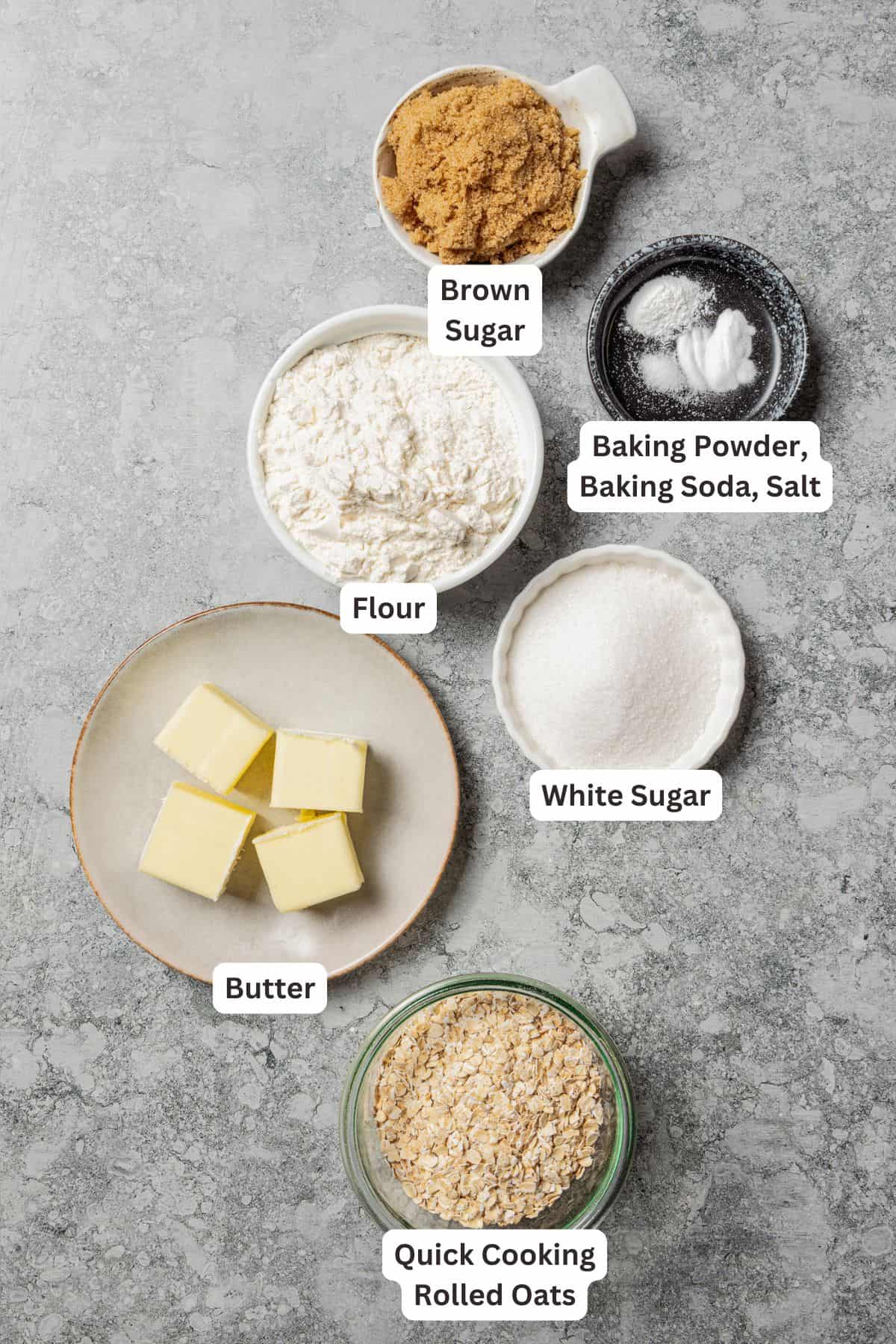 This old-fashioned apple crisp is a classic dessert, with apples, real apple cider, and warm spices baked under a light, crispy oat topping. Apple crisp topping ingredients with text labels overlaying each ingredient.