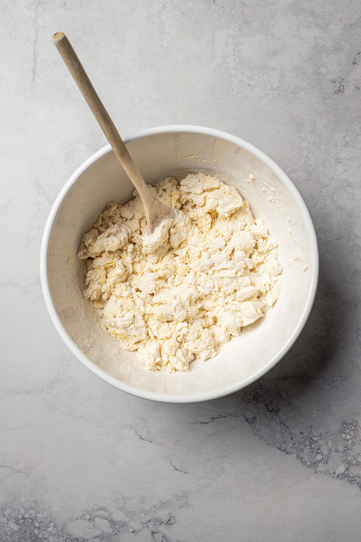 Biscuit dough partially mixed in a bowl.