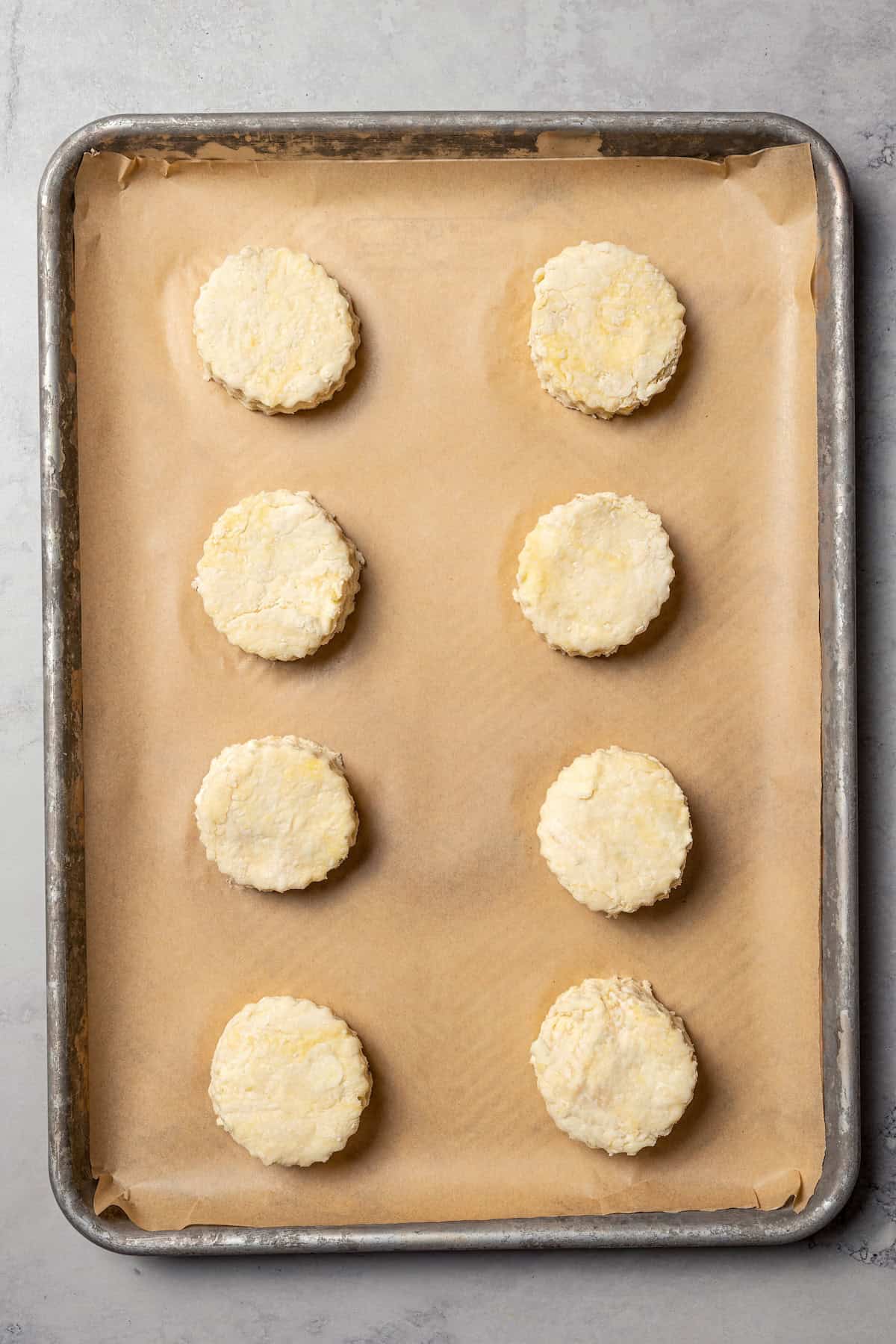 Unbaked biscuits on a baking sheet.
