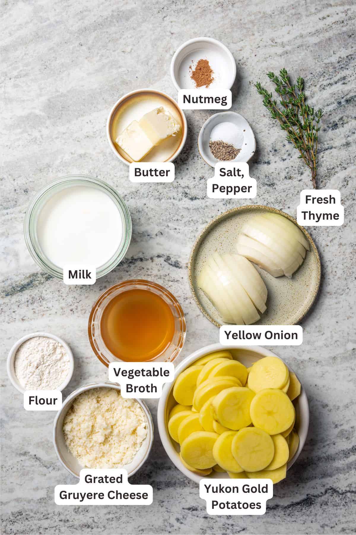 This easy scalloped potatoes recipe has thinly sliced potatoes smothered and baked in a flavorful cream sauce with nutmeg and Gruyère cheese. Scalloped potatoes recipe ingredients with text labels overlaying each ingredient.