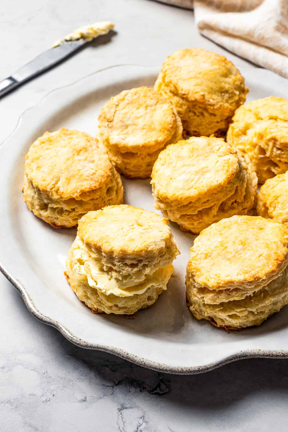 Assorted homemade buttermilk biscuits served on a white plate.