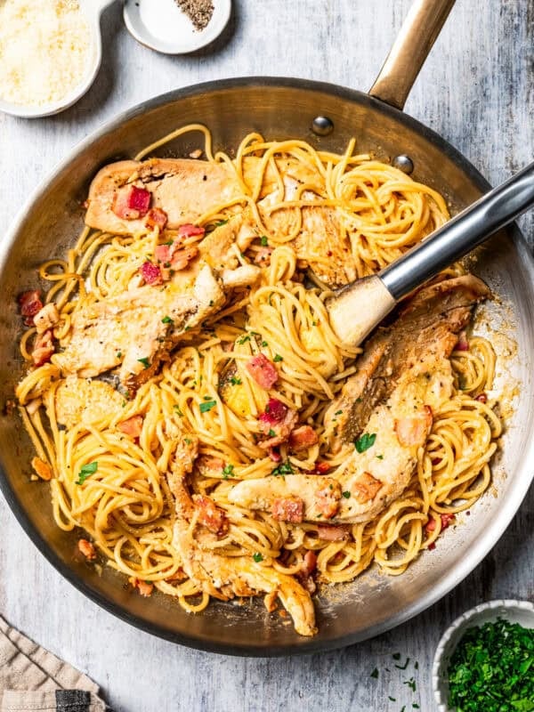 Creamy chicken and bacon pasta in a skillet.
